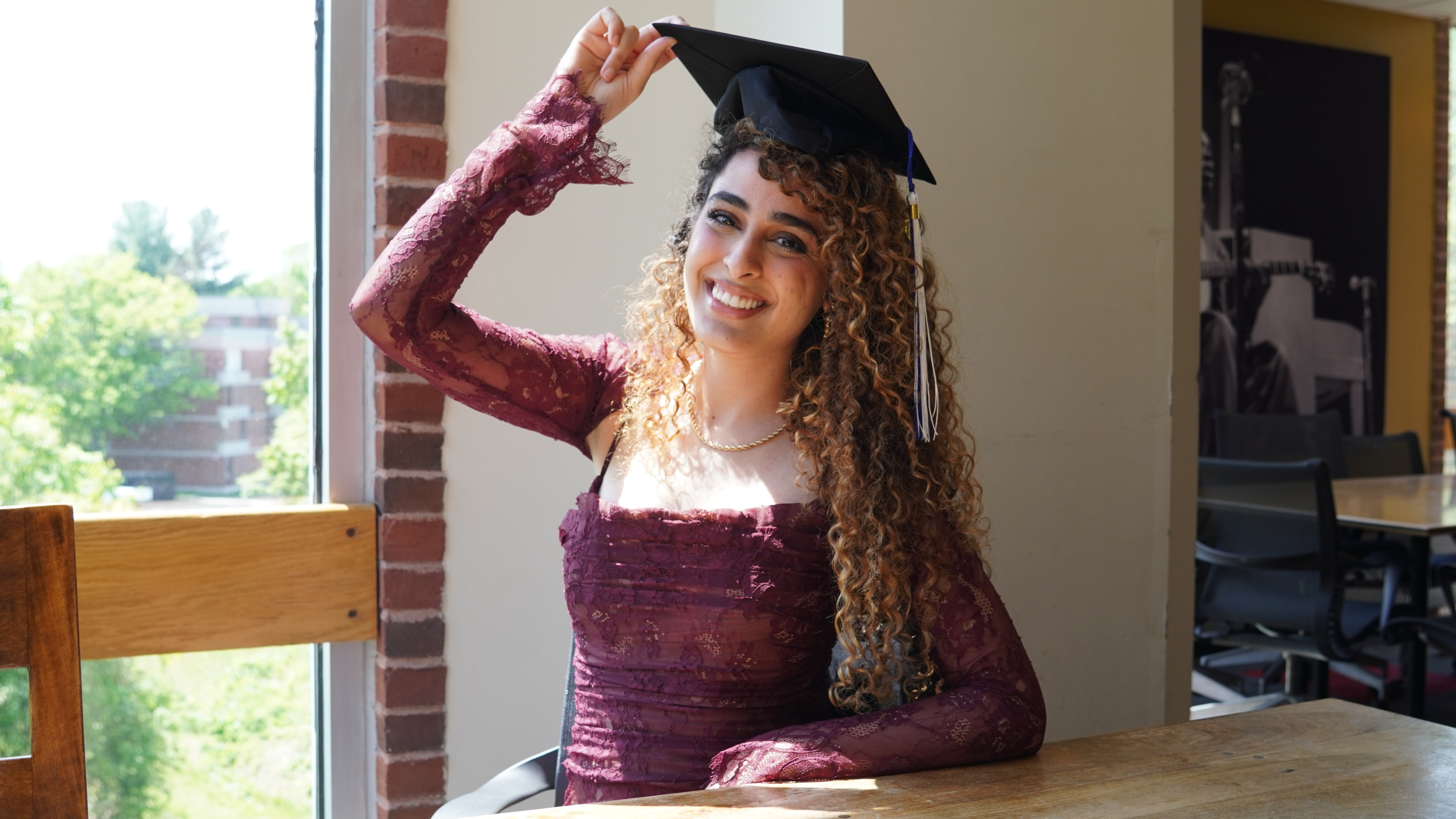 A picture of me in my graduation dress with my graduation cap on